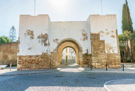 Entrance through medieval walls to historic downtown of Faro, Algarve, southern Portugal