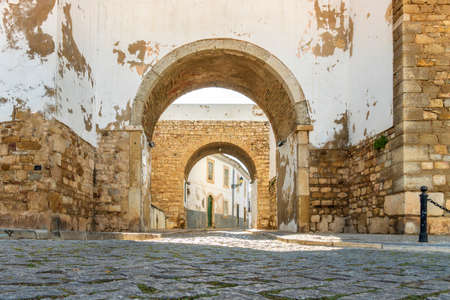 Entrance through medieval walls to historic downtown of Faro, Algarve, southern Portugalの写真素材