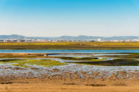 City of Faro seen from Faro Beach Peninsula with wetlands of Ria Formosa in between, Algarve, Portugalの写真素材