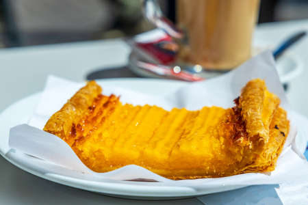 Sweet tasty pastry from Porto with coffee in the background, Portugal