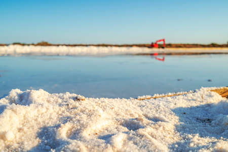 Sea salt after evaporation of ocean water on edge of the salines in Faro, Algarve, Portugal