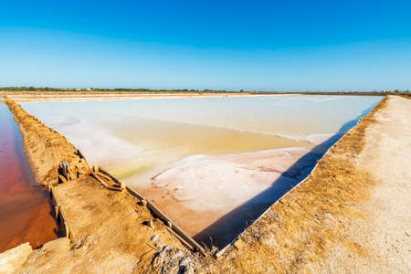 Ponds full of salt after evaporation of ocean water at salines in Faro, Algarve, Portugalの写真素材