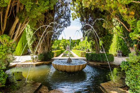 Fountain and trees in Generalife garden in Arabic palace complex called Alhambra in Granada, Spainのeditorial素材