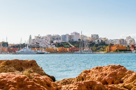 Marina in Portimao view through beautiful sandstone rocks in Ferragudo, Algarve, Portugalの写真素材