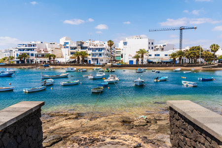 Beautiful seaside downtown of Arrecife with many boats floating on blue water, Lanzarote, Canary...