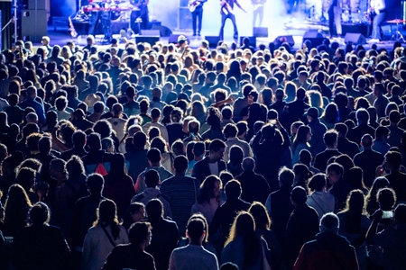 Happy people enjoying performance of popular bandの写真素材