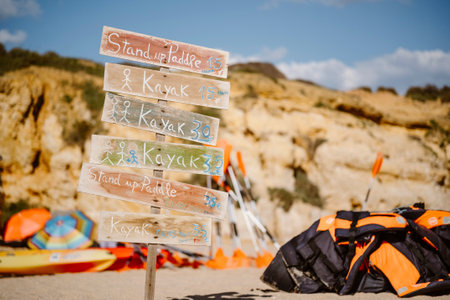 Indication with colorful objects in the background of SÃ£o Rafael's Beach, Albufeira