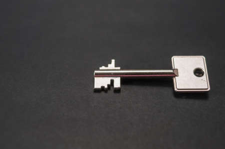A safe key, a smaller safe key against a dark backgroundの写真素材