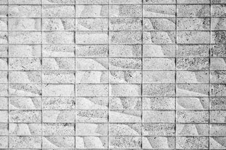 Background in symmetrical optics, bricks of the same size in a parallel, vertical arrangement, but with different surfacesの写真素材