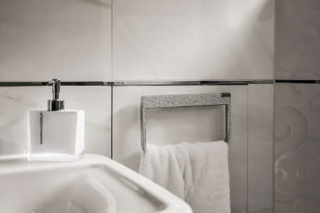 Detail of a bathroom. Manufactured towel holder with rhinestones, towel ring with white towel