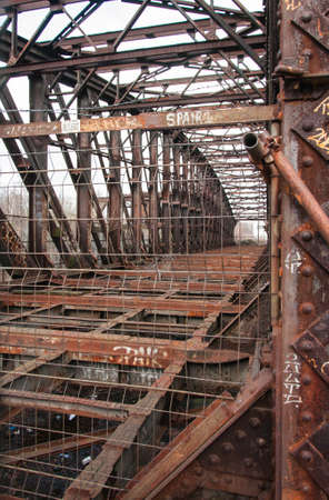 Detailed view of an old, no longer used railway bridge. It's old and very rusty.の写真素材