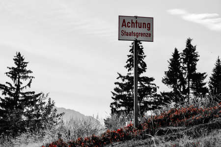 Sign in the middle of the landscape, which indicates a state borderの写真素材