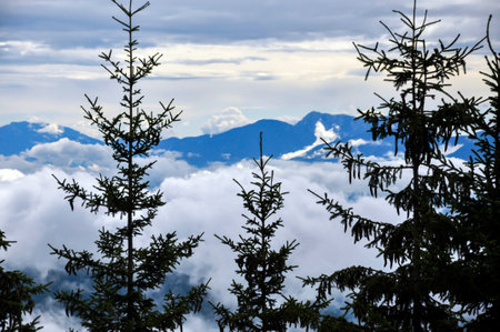 View from a mountain top of the opposite mountain range. You are above the cloudsの写真素材