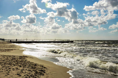 Wide Baltic Sea beach in Poland near Kolobrzeg. Beautiful late summer evening on the deserted beachの写真素材