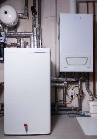 Newly built heating system with thermal storage tank and expansion tank. Installed in the basement of a family houseの写真素材