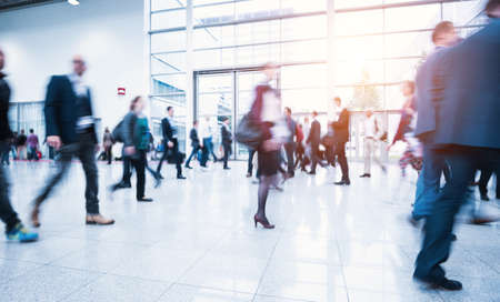 blurred people at a trade fair hallの写真素材