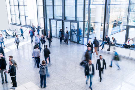 blurred people at a trade fair hallの写真素材