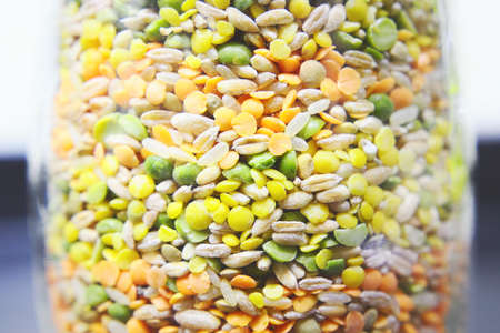 Different varieties of dried legumes in glass jar. Selective focus. Close-up.の写真素材