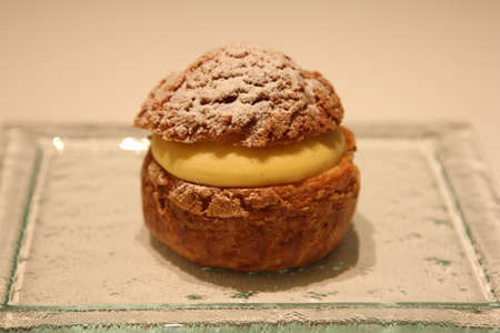 Choux pastry buns, filled with cream, on a plateの写真素材