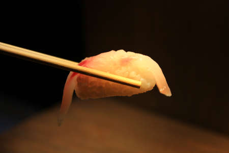 holding sushi with chopsticksの写真素材