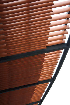 Woonden lath roof against white sky