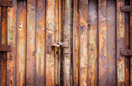 Old padlock on rusty garage collars