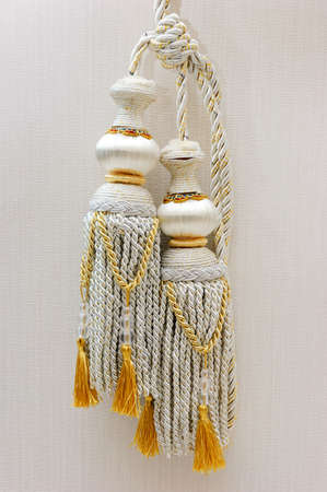 Close up silver and golden color curtain tassel の写真素材
