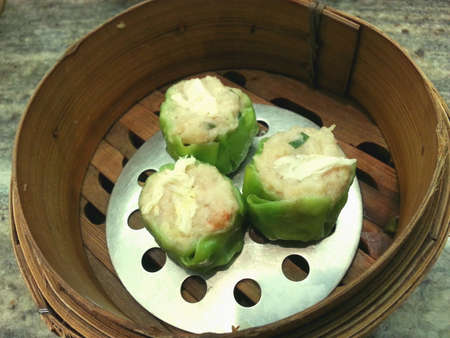 Steam crab dimsum ready to serve in basket put on the dining table.の素材