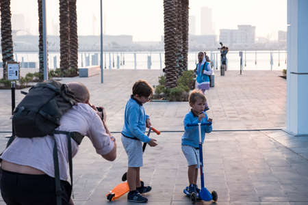 Father of two taking pictures of his sons at Louver Abu Dhabi, UAEのeditorial素材