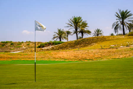Feb 26, 2018: White golf flag pole in Golf Course, Saadiyat Island, Abu Dhabi, UAE