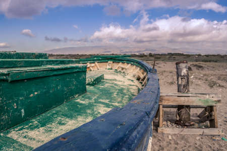 Remains of an old fishing boat on the beachの写真素材