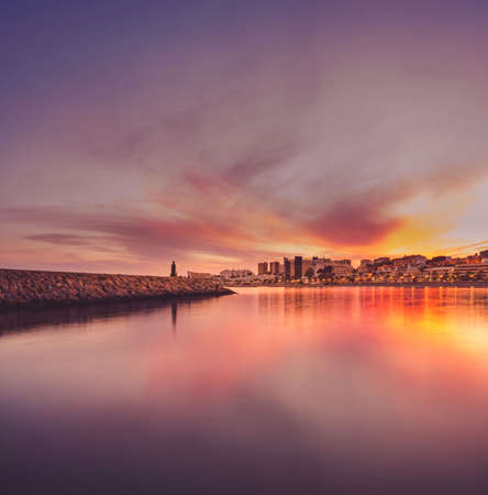 lighthouse and city skyline at sunset in Aguadulce, Roquetas de Mar, Almeria, Spainの写真素材