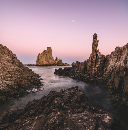 Panoramic seascape at sunset in the reef of the mermaids, in Cabo de Gata, Almeria, Spain where you can see ancient volcanic lava chimneys of millions of years old at the Mediterranean seaの写真素材