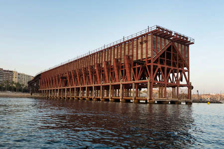 View at sunset of an iron ore loading dock built in 1904 by The Alquife Mines and Railway Company Limited, known as Cable InglÃ©s, in Almeria, an example of engineering work of iron architectureの写真素材