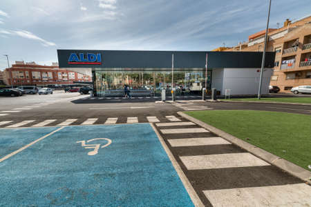 Roquetas de Mar, Spain; September 6th 2021: Facade, logo and handicapped parking lot of ALDI, a German discount supermarket chainのeditorial素材