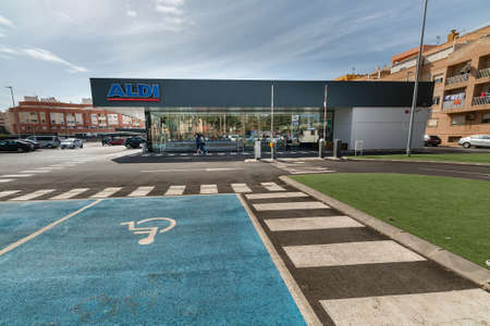 Roquetas de Mar, Spain; September 6th 2021: Facade, logo and handicapped parking lot of ALDI, a German discount supermarket chainのeditorial素材