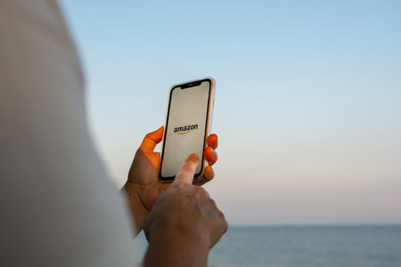 Aguadulce, Spain; October 2nd 2021: Woman's hands using her mobile phone. Making online purchases on the amazon app looking for prime day or black friday dealsのeditorial素材