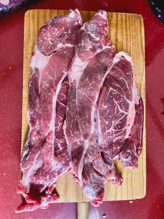 Raw American Angus entrecote beef steak aged on a wooden board. Veal chop. Beef.の写真素材