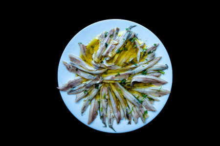 top zenithal view of a tapa plate of boquerones en vinagre (pickled anchovies in vinegar)の写真素材