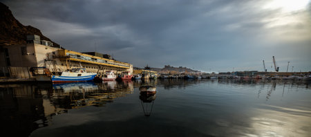 Fishing boats next to the fish market in the fishing port of Almeria on a cloudy day.の写真素材