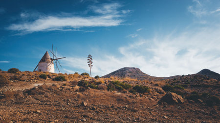 picturesque typical windmill on the hill, in san jose, natural park of cabo de gata nijarの写真素材