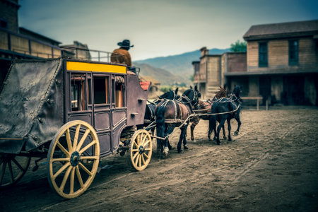 Stagecoach enters town square in American old wild Westの写真素材