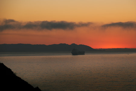 cargo ship in the bay at dawnの写真素材