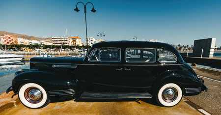 40s classic car. Black car with silver rim tires and white wheels. side viewの写真素材