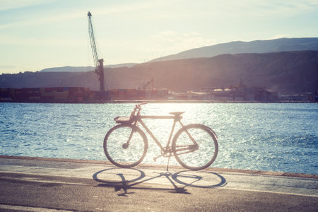 A bicycle in the foreground illuminated by sunlightの写真素材