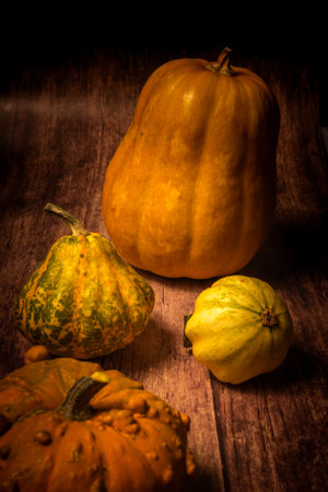 Autumn still life with pumpkins on wooden background. Toned.の写真素材