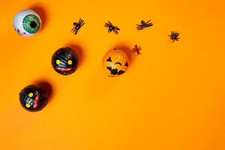Halloween decoration. Pumpkins and spiders on orange background. Top view.の写真素材