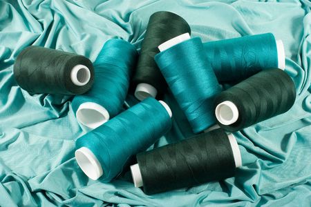 Middle green and dark green threads on light green clothの写真素材