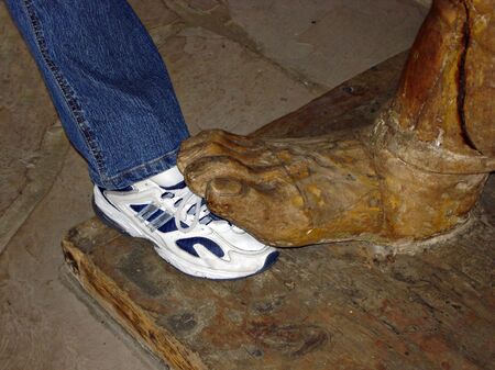 Wooden Big Foot and Leg in Jeans and Sneakerの写真素材