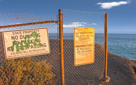 Ugly Brown Rusty Fence at Beautiful but Dangerous Ocean Cliff